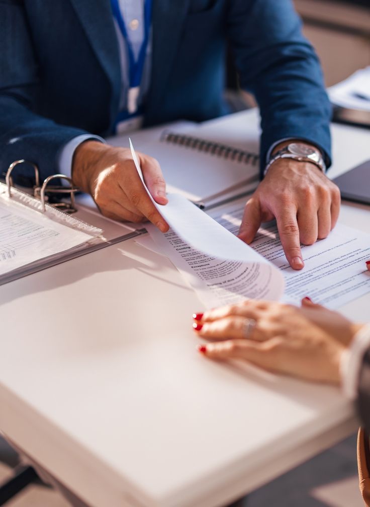 Business professional reviewing HR contract documents with a client in Dubai.